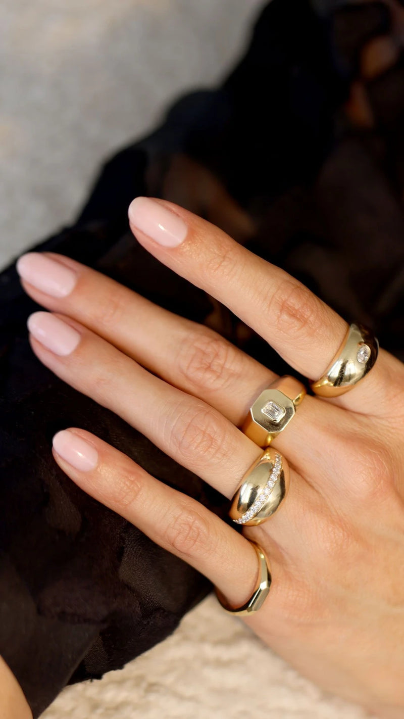 Yellow gold diamond fashion rings on woman's hand