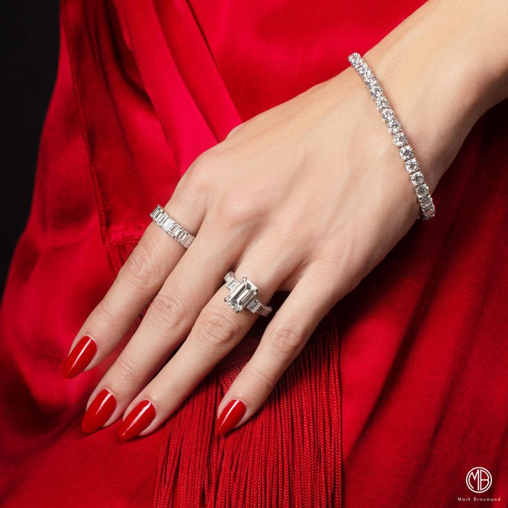 A woman dressed in red wears holiday jewelry gifts under $1,000 that look far more expensive.