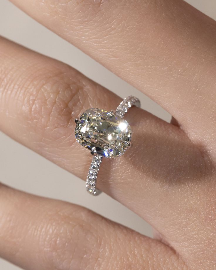 A woman wears her ideal Engagement Ring based on the ultimate guide to Lab Grown Diamond Engagement Rings.