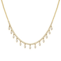 Round brilliant cut diamond and marquise diamond drop necklace set in yellow gold. 