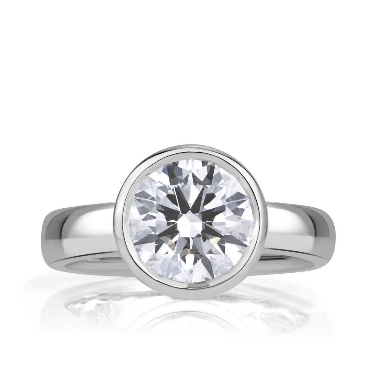 Round Brilliant Cut Diamond bezel set in white gold with a thick band. 
