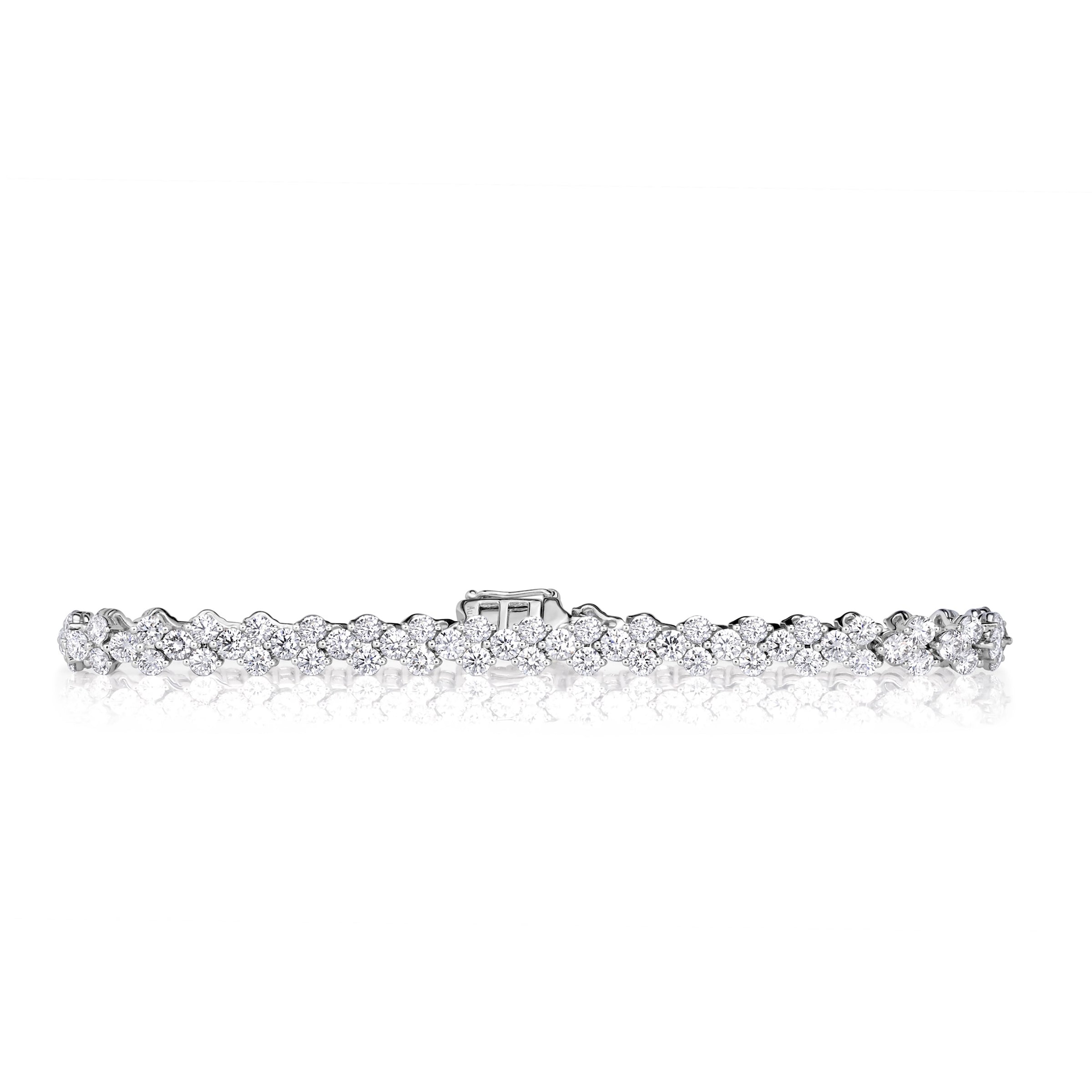 18k White Gold round brilliant cut diamond bracelet with staggering diamonds clustered in sets of three. 