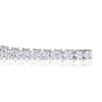 Detailed shot of oval cut diamond tennis bracelet in 18k white gold set with 4 prongs. 