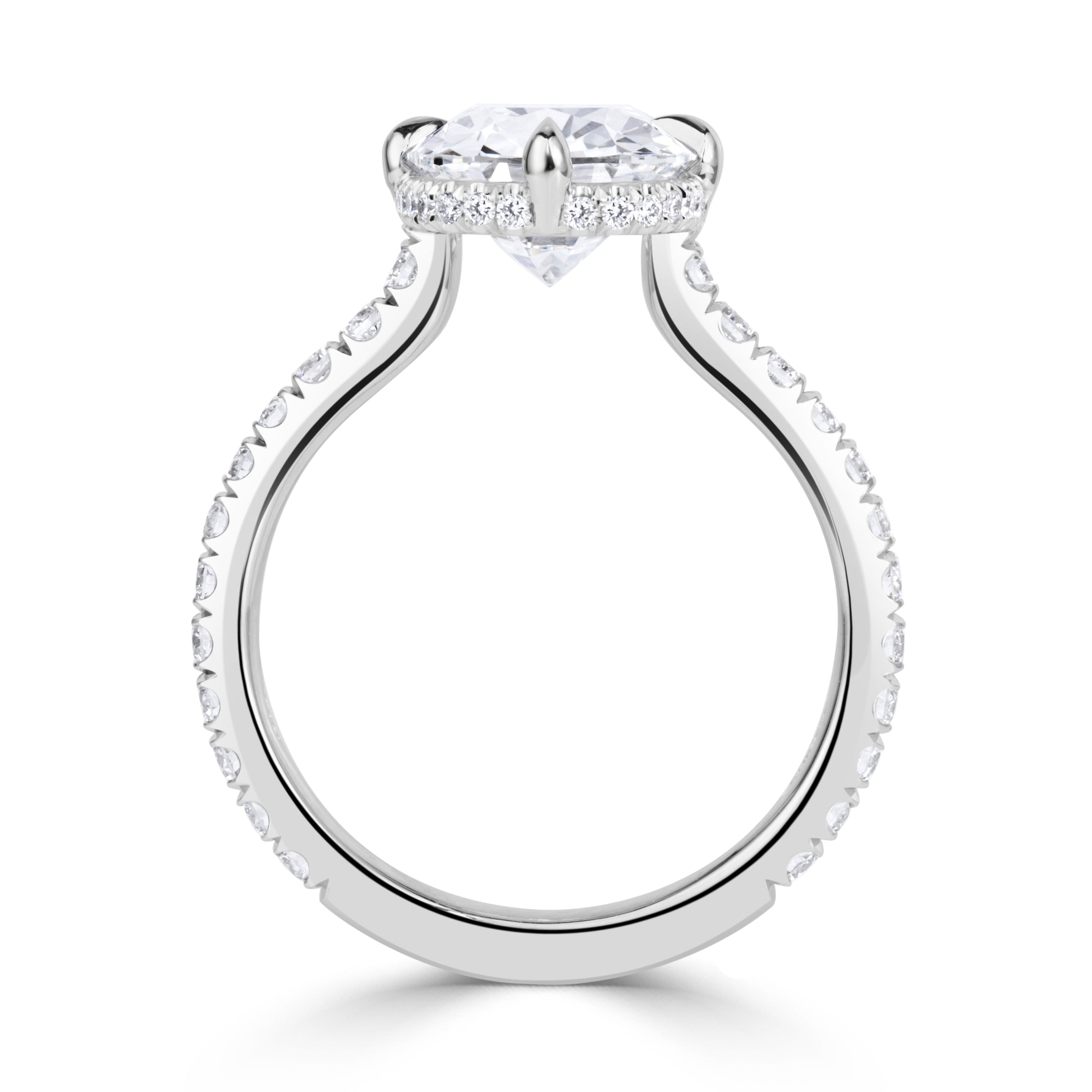 Platinum engagement ring with an elongated old mine cut diamond set with 4 prongs in a compass style, pave diamond band and hidden halo of diamonds under the center stone. 