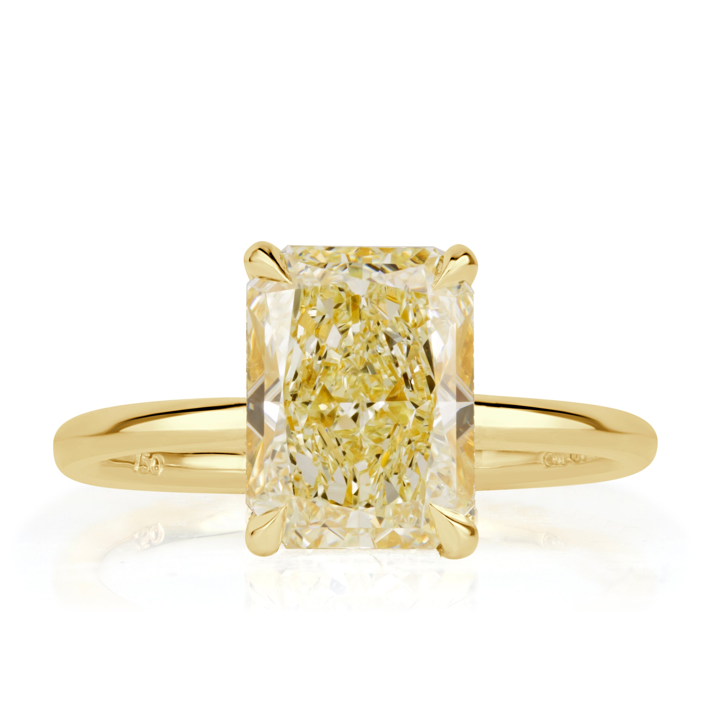 Elongated cushion cut canary yellow diamond with a hidden halo and yellow gold band. 