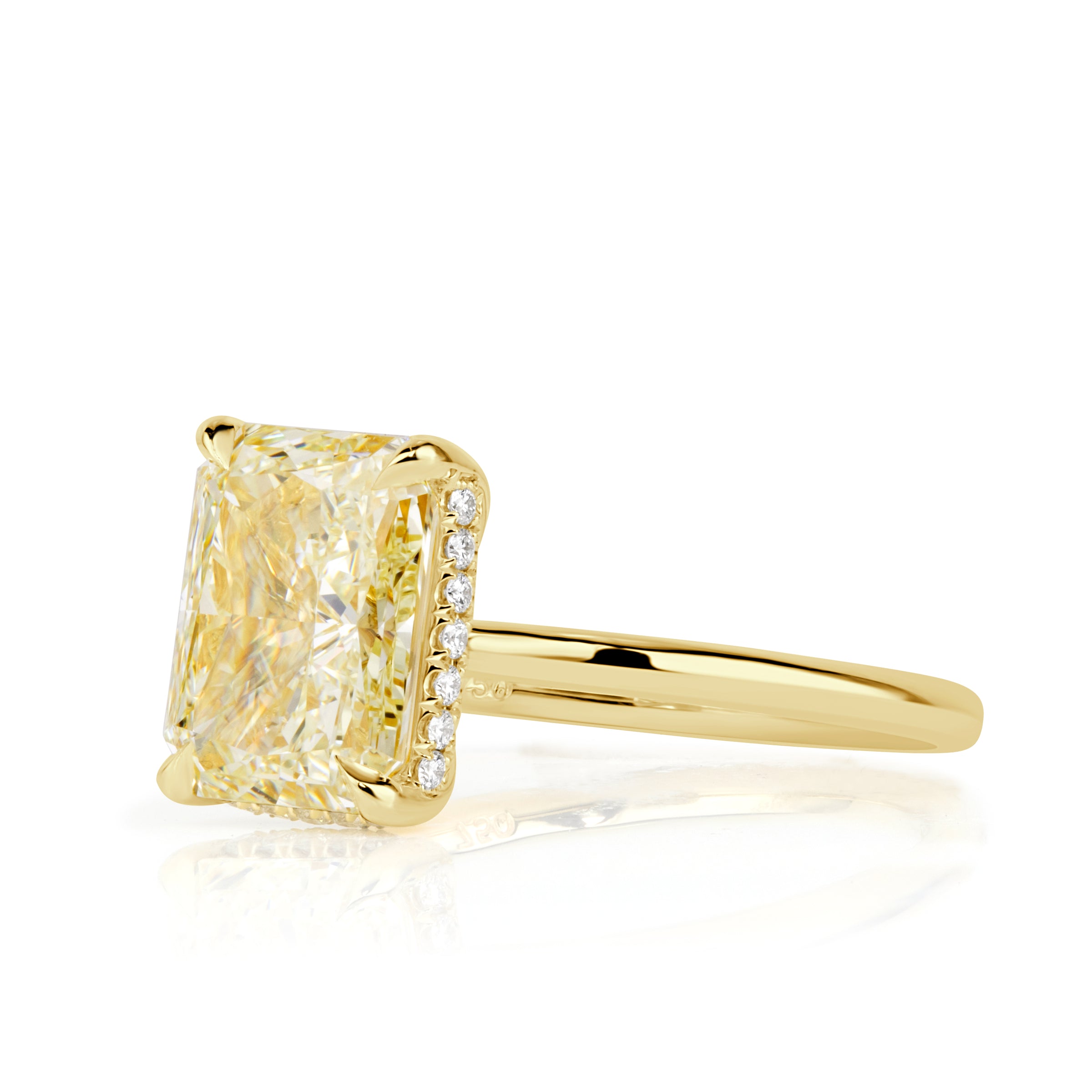 Elongated cushion cut canary yellow diamond with a hidden halo and yellow gold band. 