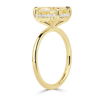 Elongated cushion cut canary yellow diamond with a hidden halo and yellow gold band. 