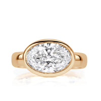 Oval lab diamond bezel set horizontally with 4mm polished band. 
