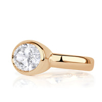 Oval lab diamond bezel set horizontally with 4mm polished band. 