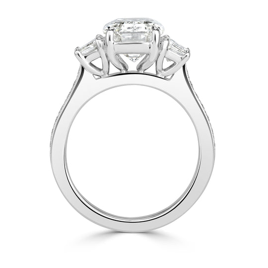 Tri stone silver emerald cut diamond engagement ring.